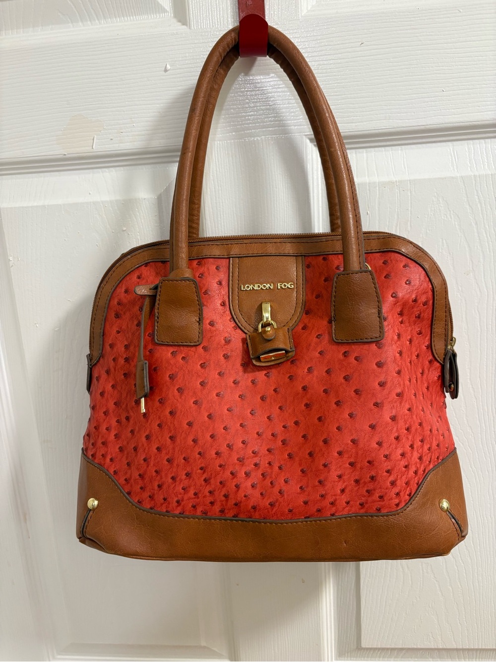 London Fog satchel features a distinctive red ostrich print and lock& key